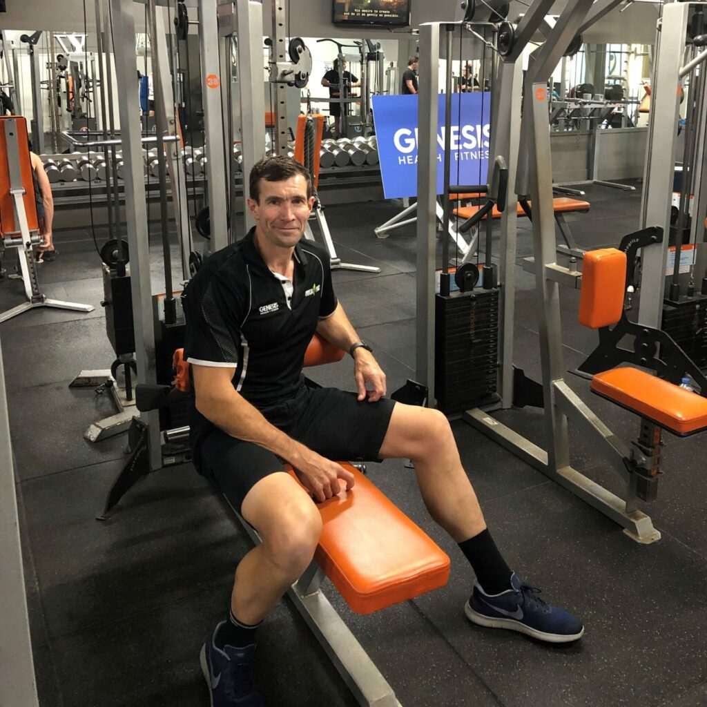 John Pirlo sitting on gym equipment Genesis club